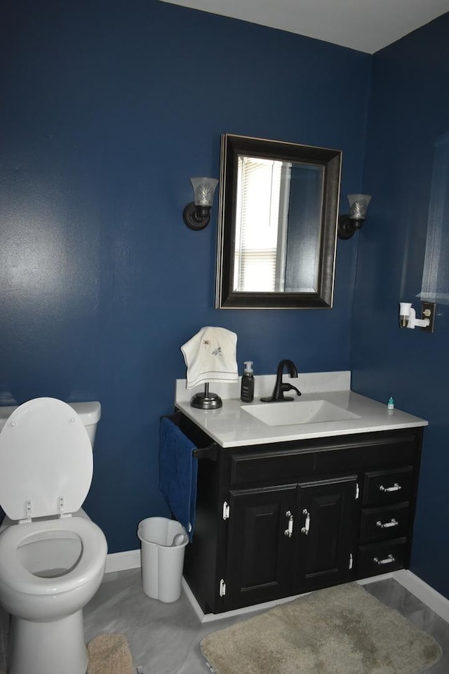 bathroom featuring vanity and toilet