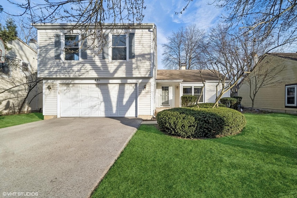 view of front facade with a front lawn and a garage