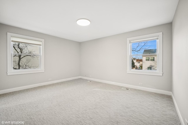 empty room featuring carpet flooring and a healthy amount of sunlight