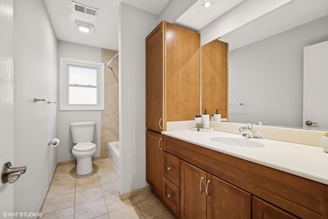 full bathroom featuring tile patterned flooring, vanity, toilet, and tiled shower / bath combo