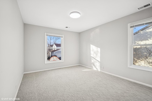 carpeted empty room with plenty of natural light