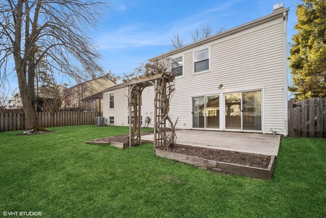 back of property featuring a lawn and a patio area