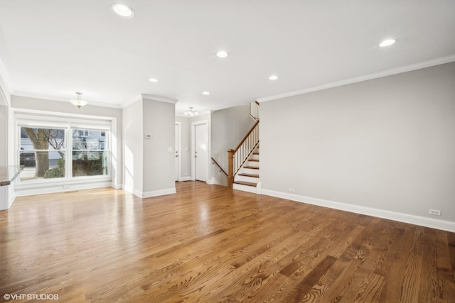 unfurnished living room with light hardwood / wood-style floors and ornamental molding