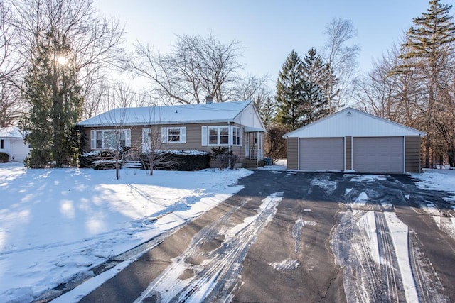 ranch-style home featuring a garage and an outbuilding