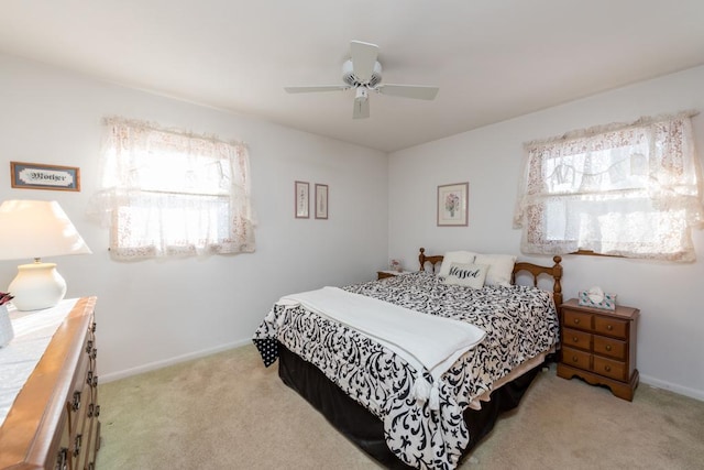 bedroom with ceiling fan and light carpet