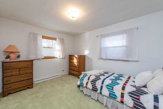 bedroom featuring baseboard heating and light carpet