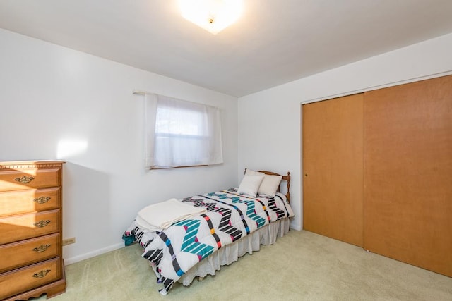 carpeted bedroom featuring a closet