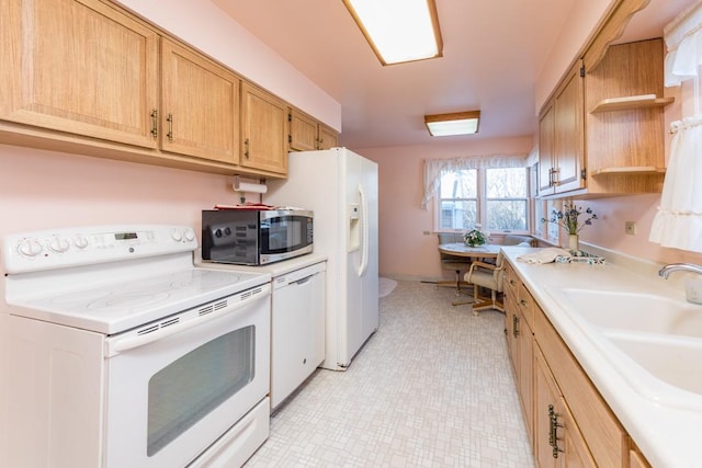 kitchen featuring white appliances and sink