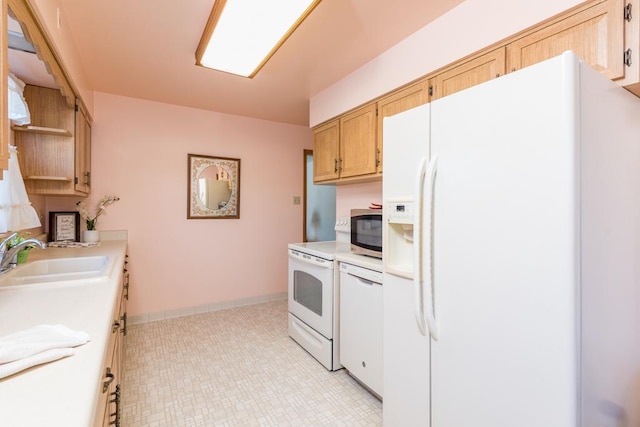 kitchen with white appliances, light brown cabinets, and sink