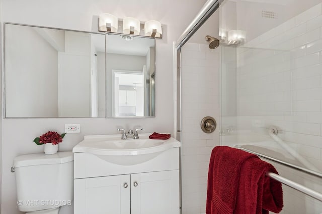 bathroom featuring vanity, toilet, and walk in shower