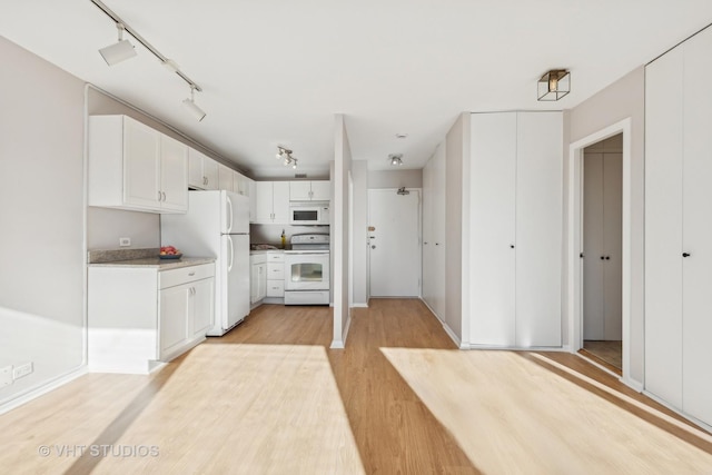 kitchen featuring white cabinets, light hardwood / wood-style floors, white appliances, and rail lighting