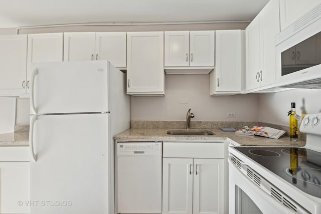 kitchen featuring white cabinets, white appliances, light stone countertops, and sink