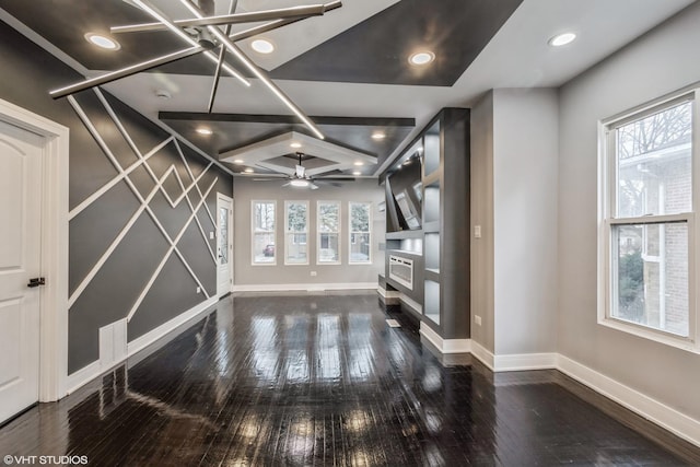 unfurnished living room featuring ceiling fan, a fireplace, and dark wood-type flooring