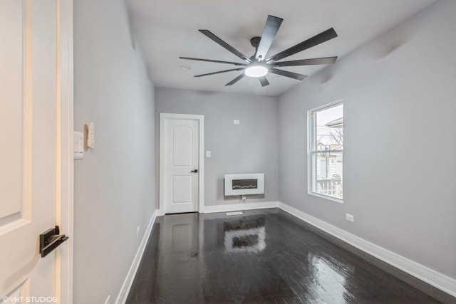 spare room featuring ceiling fan and dark hardwood / wood-style flooring