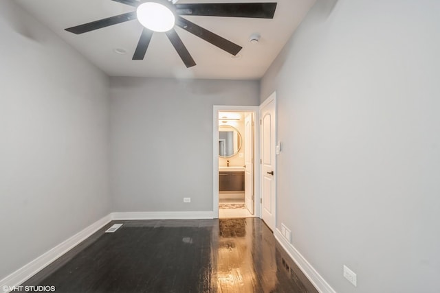 unfurnished bedroom featuring connected bathroom, ceiling fan, and dark hardwood / wood-style floors