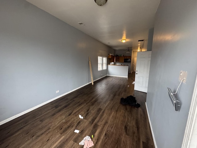 unfurnished living room with dark hardwood / wood-style floors