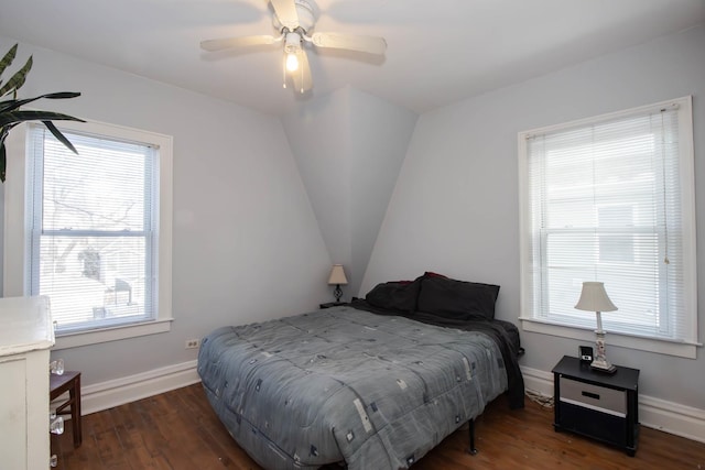 bedroom with ceiling fan, lofted ceiling, dark wood-type flooring, and multiple windows