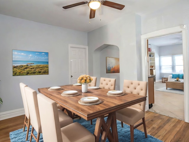 dining room with hardwood / wood-style flooring and ceiling fan