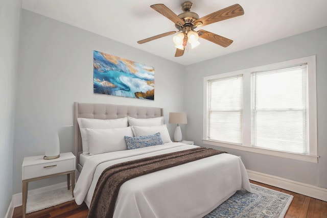 bedroom with ceiling fan and dark hardwood / wood-style flooring