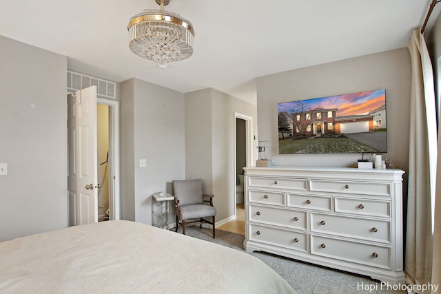 bedroom featuring carpet flooring and a notable chandelier