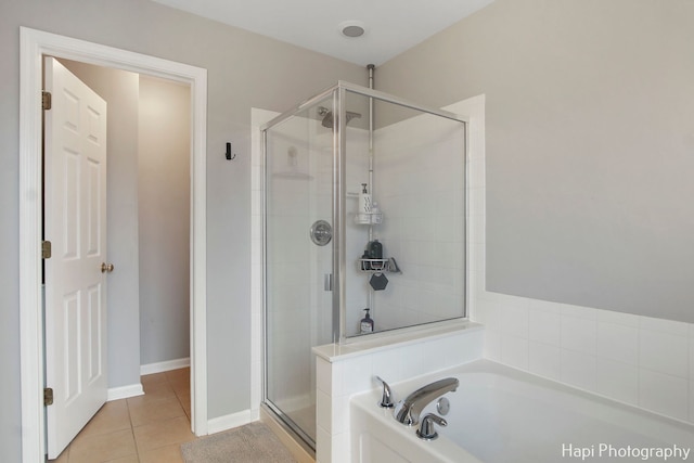 bathroom with tile patterned flooring and independent shower and bath