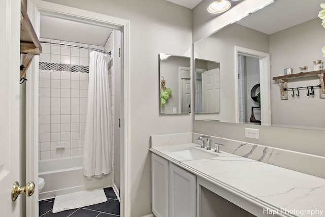 bathroom featuring tile patterned floors, vanity, and shower / bathtub combination with curtain