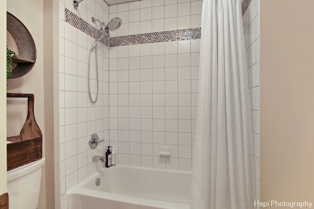 bathroom featuring shower / bath combo and toilet