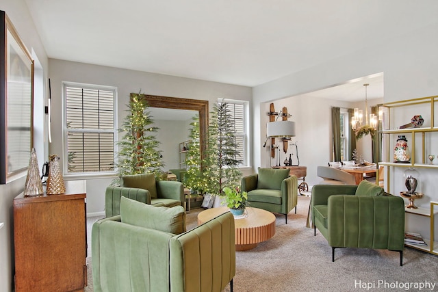 living room featuring a chandelier and carpet floors