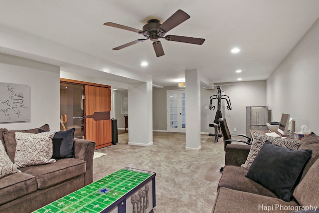 living room with light carpet, french doors, and ceiling fan