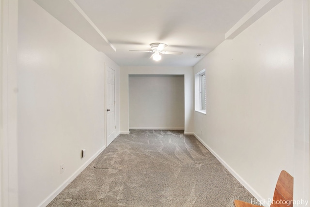 empty room featuring ceiling fan and carpet floors