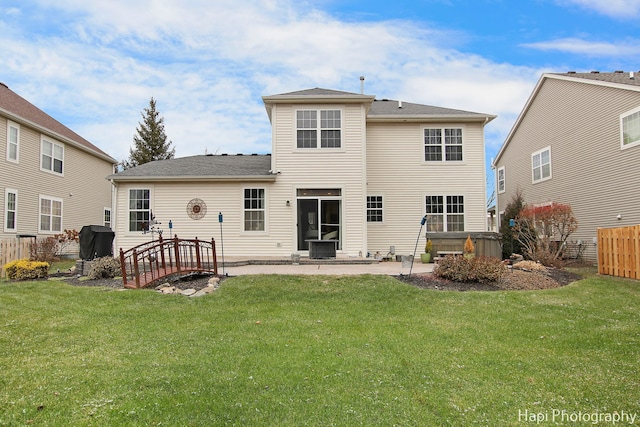 rear view of property featuring a yard and a patio