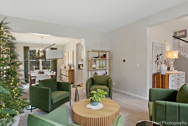 carpeted living room featuring a chandelier