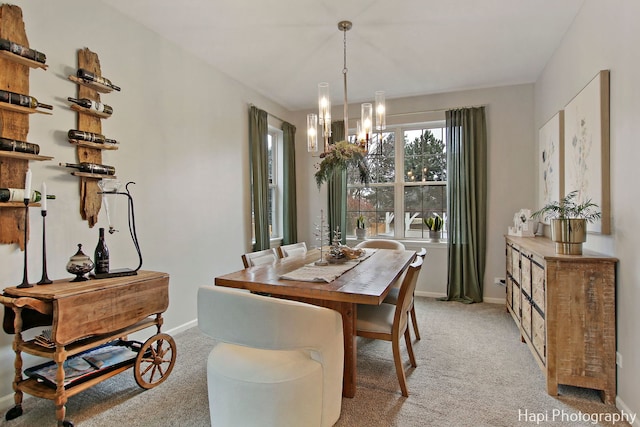 carpeted dining space with an inviting chandelier