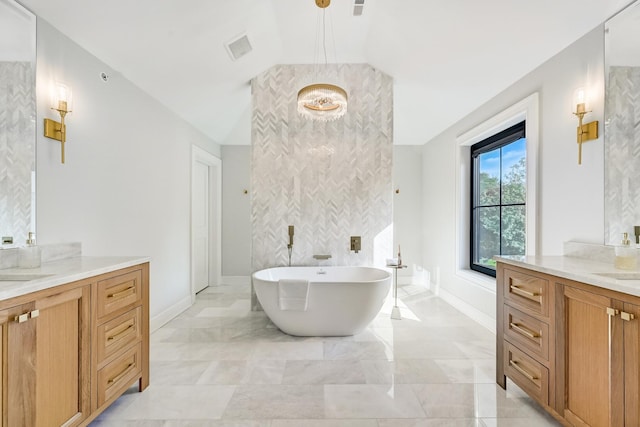 bathroom with vanity and a bath