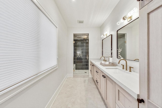 bathroom with vanity and a shower with door