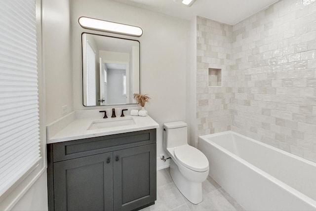 full bathroom featuring tiled shower / bath, tile patterned flooring, vanity, and toilet