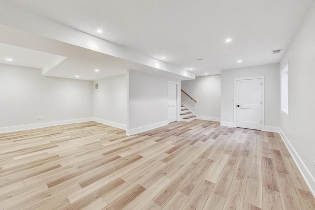 basement with light hardwood / wood-style flooring