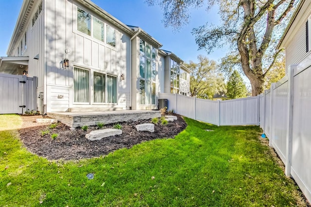 rear view of property featuring a lawn