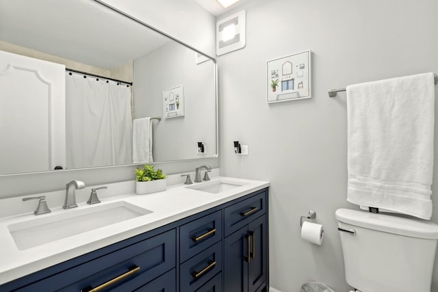 bathroom with toilet and vanity