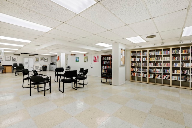 interior space with a paneled ceiling