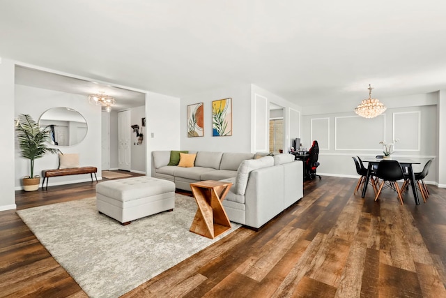 living room featuring a notable chandelier and dark hardwood / wood-style flooring