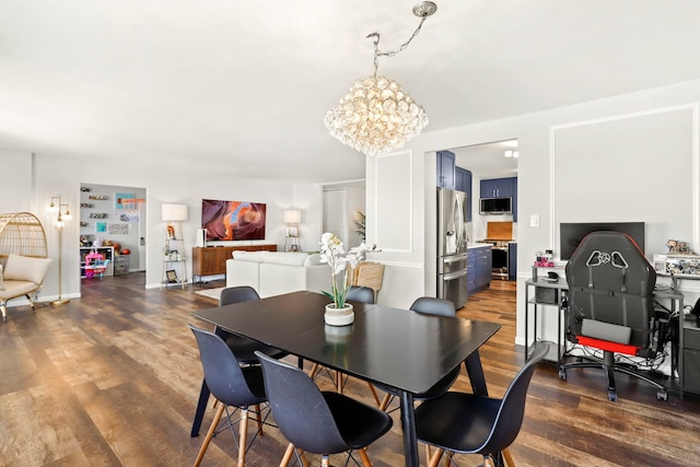 dining area featuring dark wood-type flooring and a notable chandelier