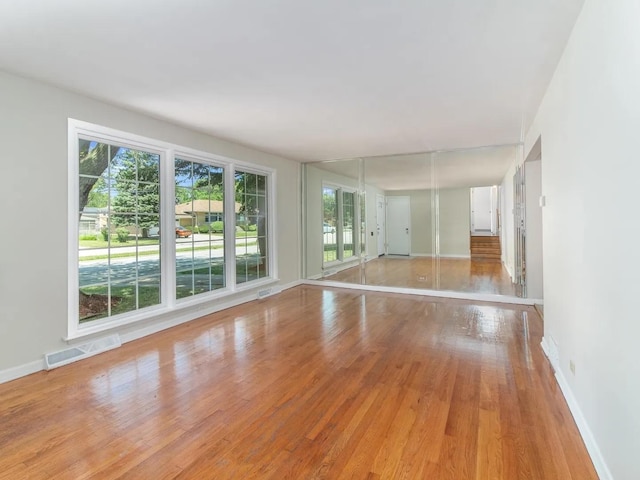 spare room with light hardwood / wood-style floors