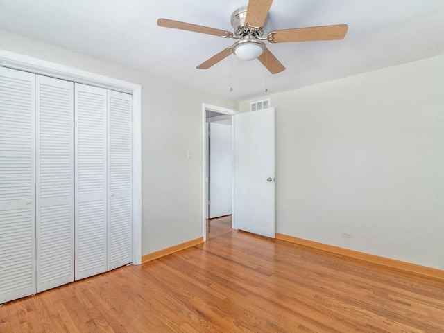 unfurnished bedroom featuring ceiling fan, a closet, and light hardwood / wood-style flooring