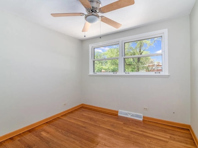 unfurnished room with ceiling fan and hardwood / wood-style flooring