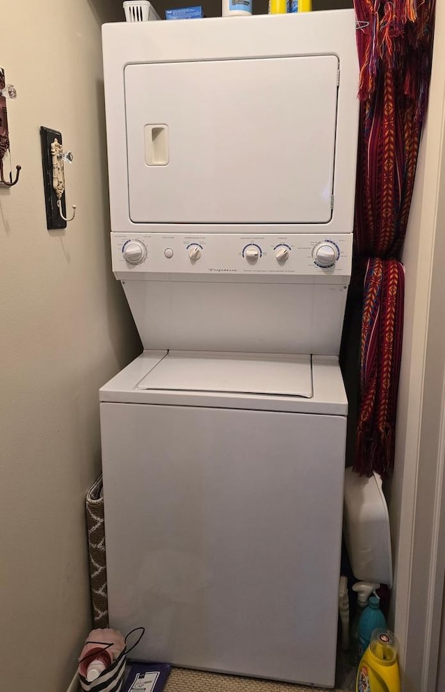 clothes washing area with stacked washer and dryer