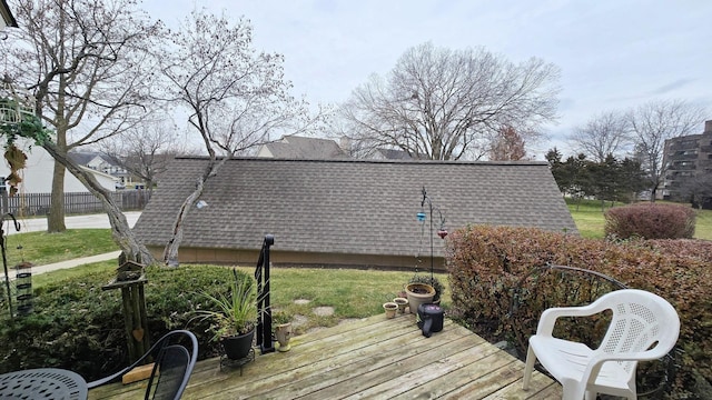 wooden deck featuring a lawn