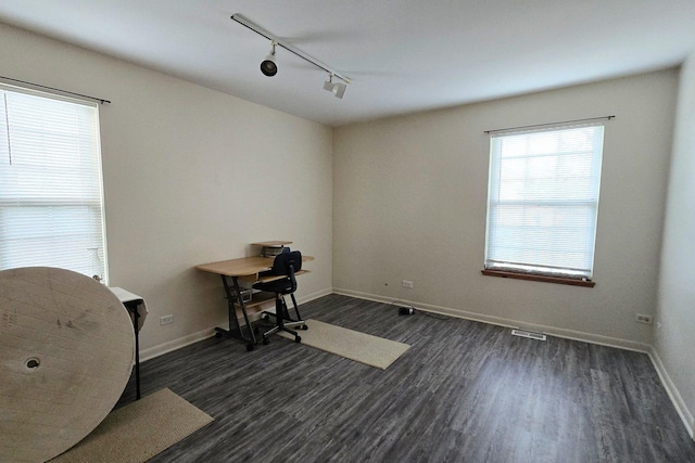 office space with track lighting and dark hardwood / wood-style floors