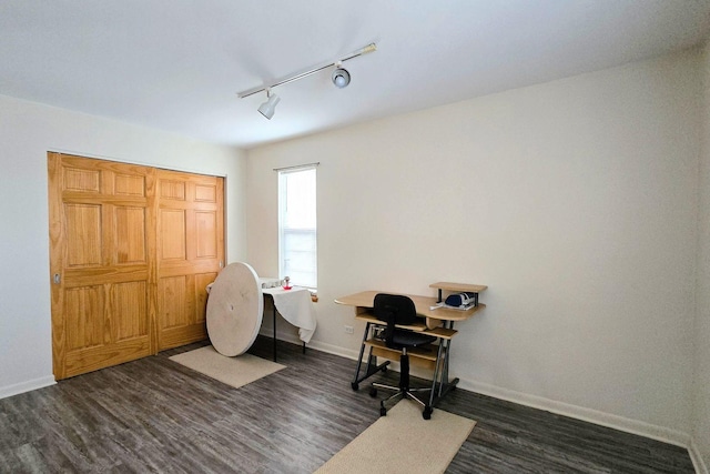 office space featuring track lighting and dark wood-type flooring