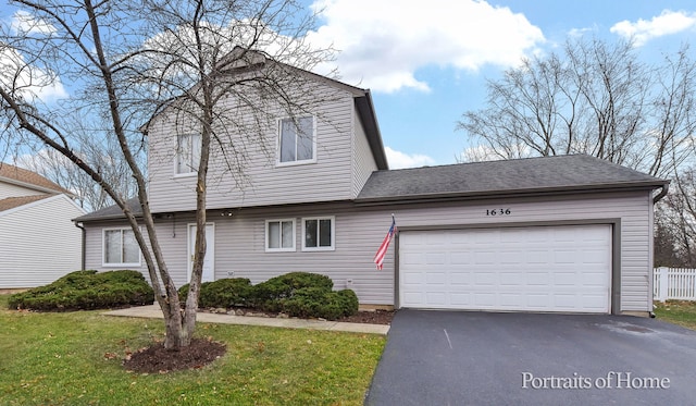 view of front of property with a garage and a front yard